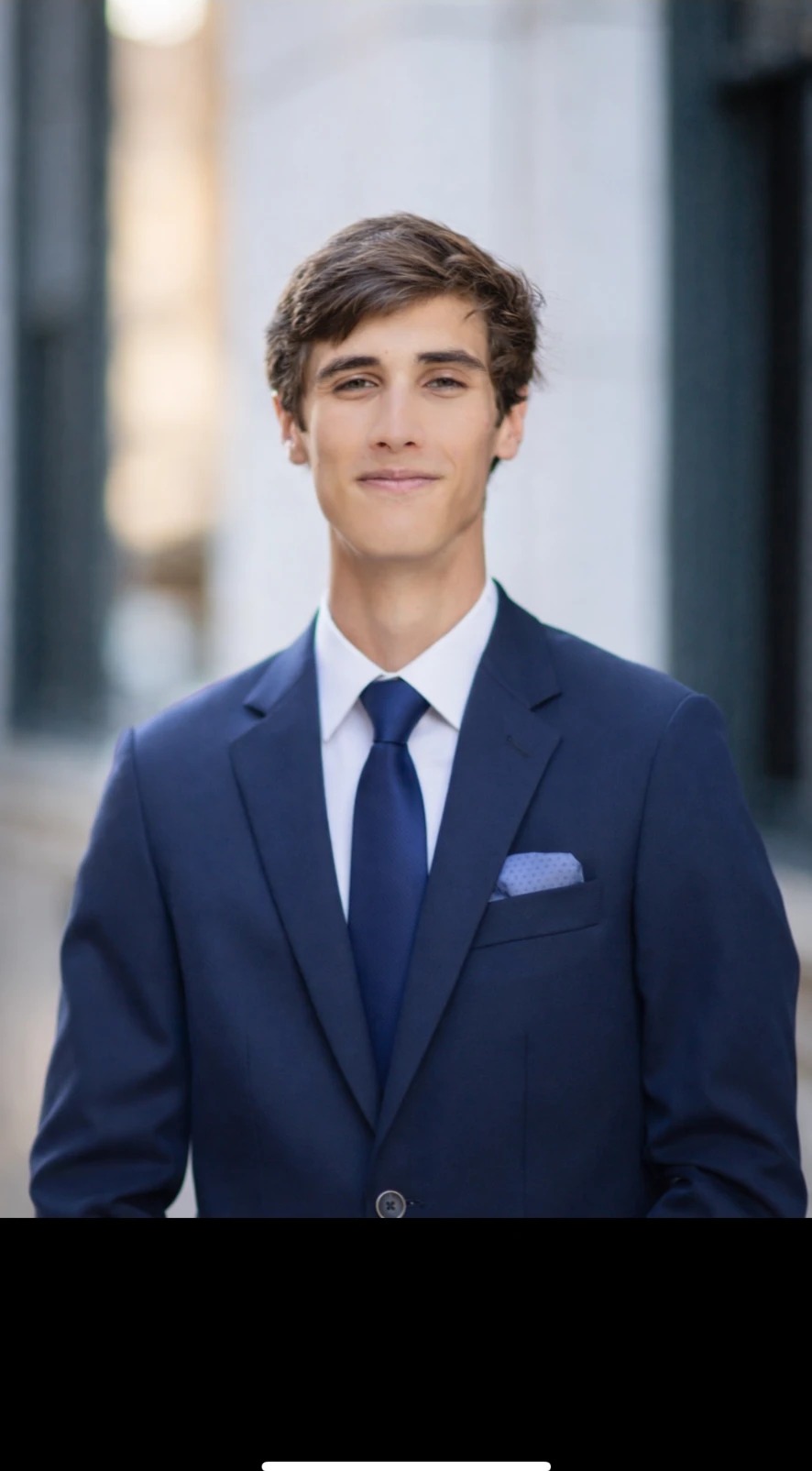 Portrait of Ethan Saxon in a navy suit